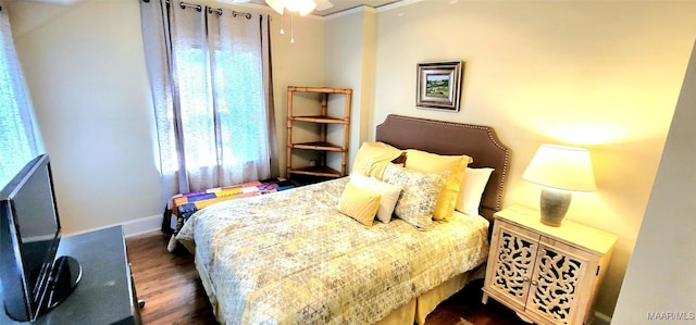 bedroom featuring crown molding and dark hardwood / wood-style flooring