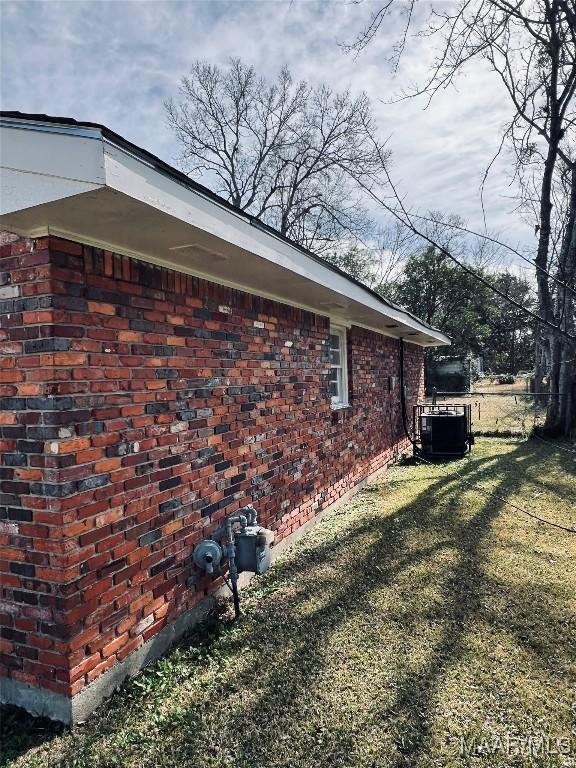 view of property exterior featuring a yard and central AC