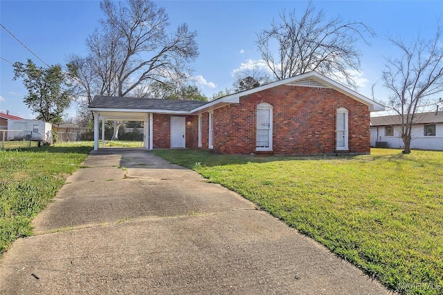 view of front of property featuring brick siding, an attached carport, a front lawn, and fence