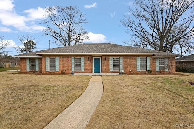 ranch-style house with brick siding, roof with shingles, and a front yard