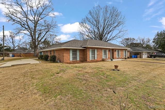 exterior space with brick siding and a yard