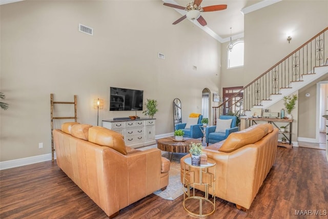 living room with crown molding, dark hardwood / wood-style flooring, and ceiling fan