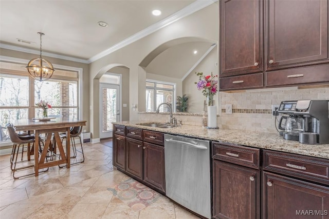 kitchen with decorative light fixtures, sink, light stone counters, dishwasher, and decorative backsplash