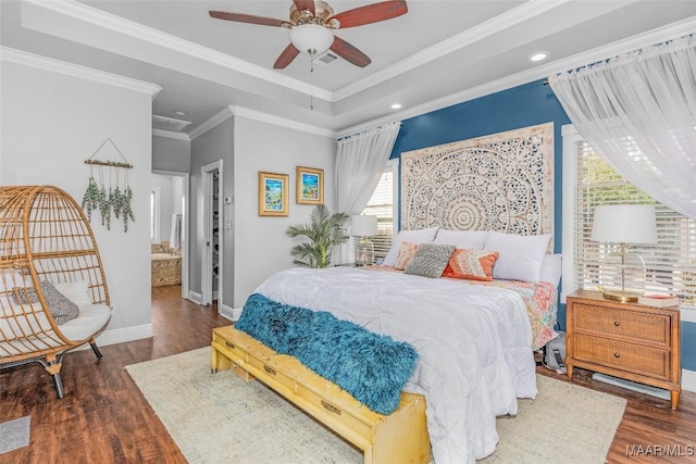 bedroom featuring a tray ceiling, crown molding, and dark hardwood / wood-style floors