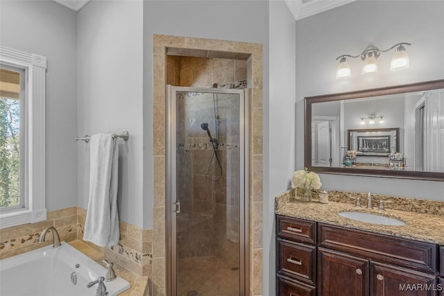 bathroom featuring ornamental molding, vanity, and shower with separate bathtub