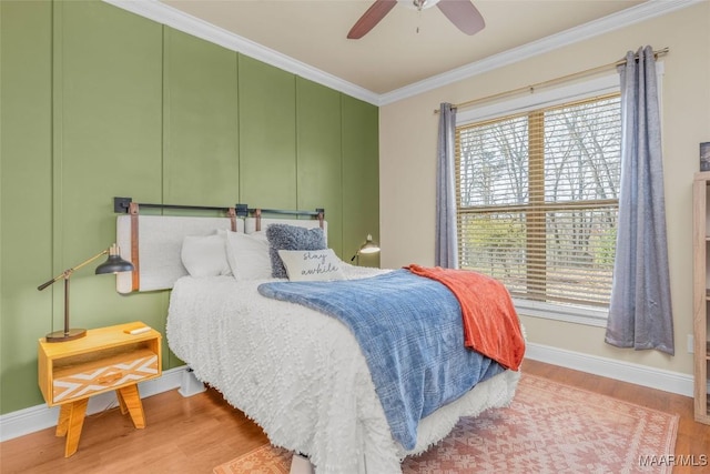 bedroom featuring ceiling fan, ornamental molding, and light hardwood / wood-style flooring