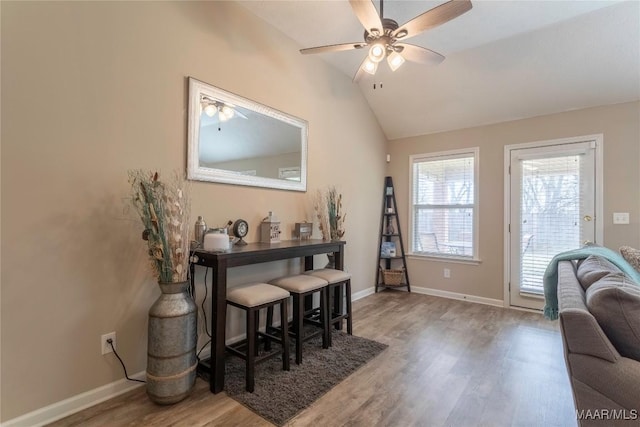 interior space with hardwood / wood-style flooring, ceiling fan, and vaulted ceiling