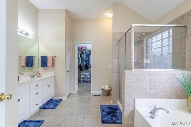 bathroom featuring tile patterned floors, plus walk in shower, and vanity