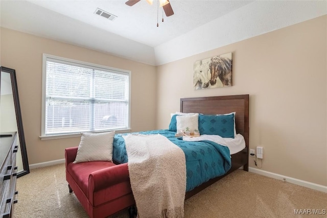 bedroom with ceiling fan, vaulted ceiling, and light colored carpet