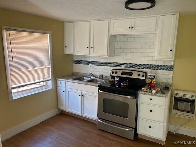 kitchen featuring stainless steel electric range oven, dark hardwood / wood-style floors, white cabinets, heating unit, and decorative backsplash