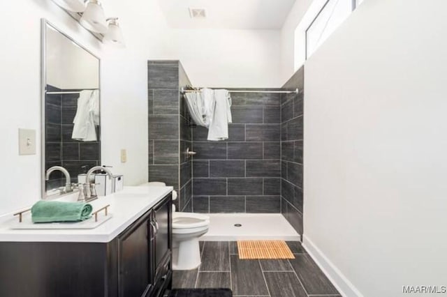 bathroom with vanity, curtained shower, and toilet