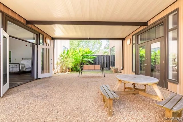 sunroom with french doors and beam ceiling