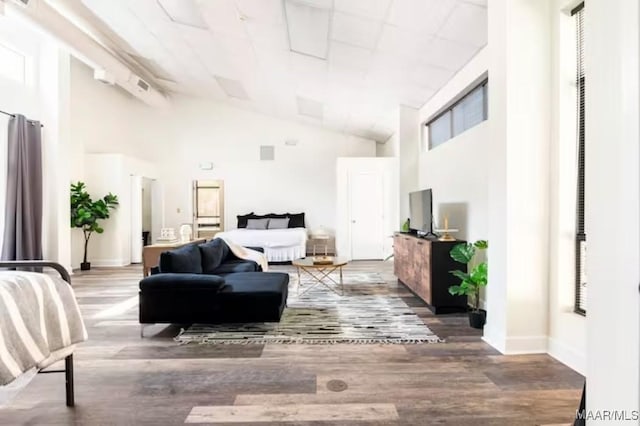 living room with high vaulted ceiling and wood-type flooring