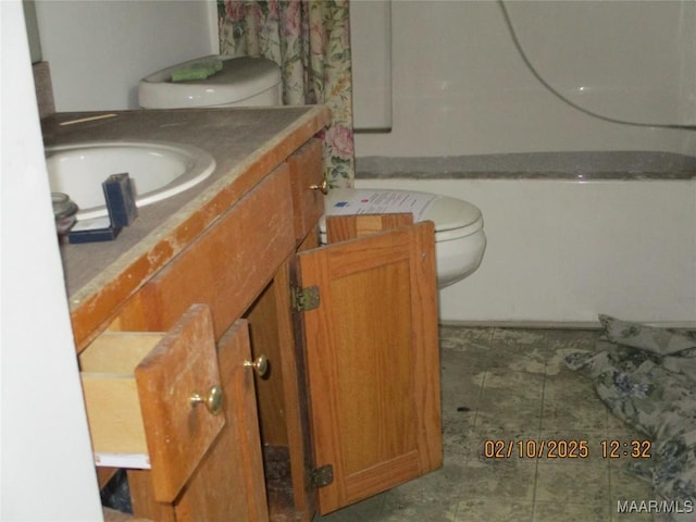 bathroom featuring vanity, toilet, and tile patterned floors