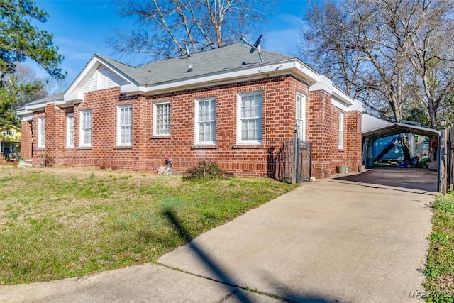 view of home's exterior with a yard and a carport