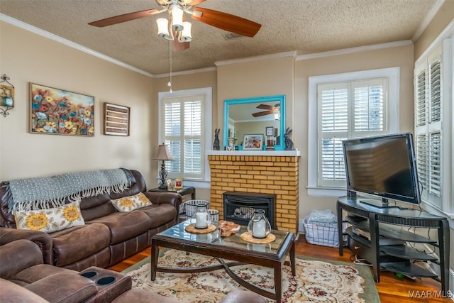 living room with hardwood / wood-style flooring, crown molding, a wealth of natural light, and a textured ceiling