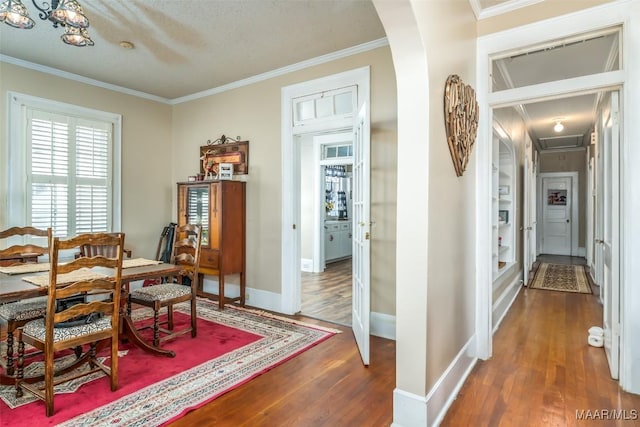 dining room with ornamental molding and dark hardwood / wood-style floors