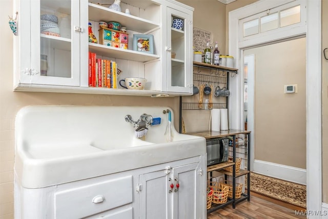 interior space featuring hardwood / wood-style flooring and white cabinetry