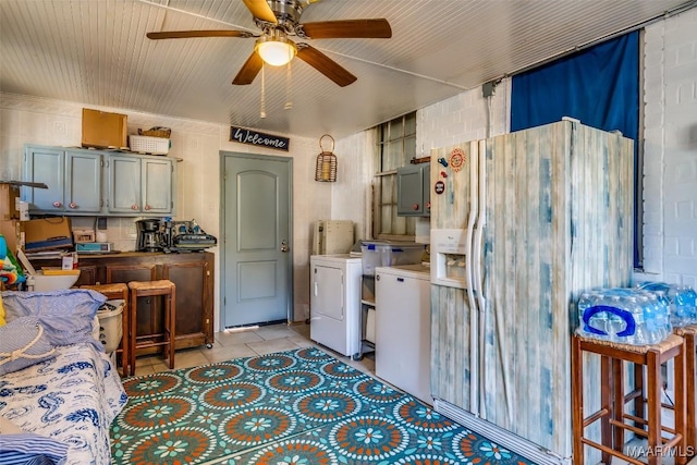 kitchen featuring white fridge with ice dispenser, light tile patterned flooring, and ceiling fan