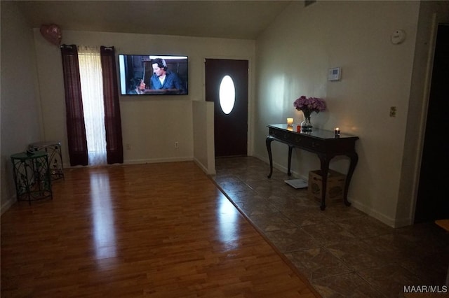 foyer with vaulted ceiling and dark hardwood / wood-style floors