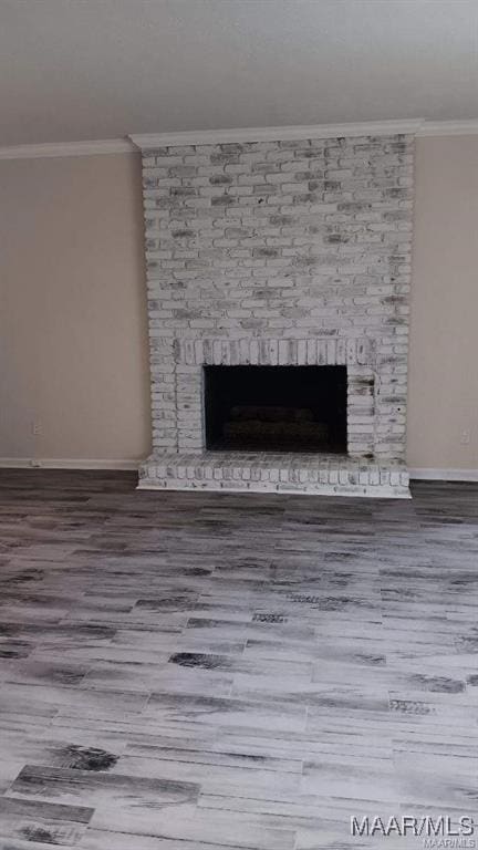 interior details featuring a fireplace, crown molding, and hardwood / wood-style floors