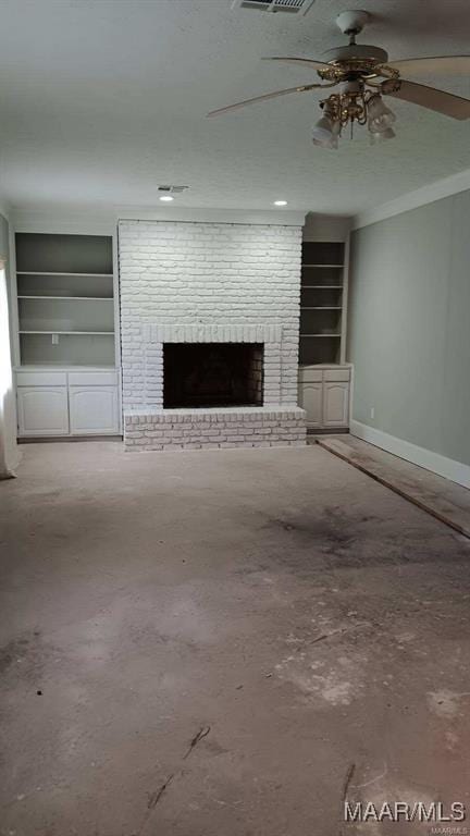 unfurnished living room with ceiling fan, built in shelves, a brick fireplace, and concrete floors