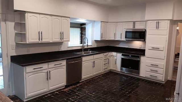 kitchen featuring sink, appliances with stainless steel finishes, and white cabinets