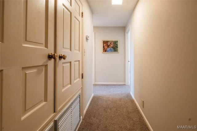 hall featuring baseboards and carpet floors