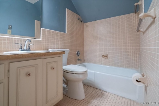 full bath featuring vanity, tile walls, toilet, tile patterned floors, and vaulted ceiling