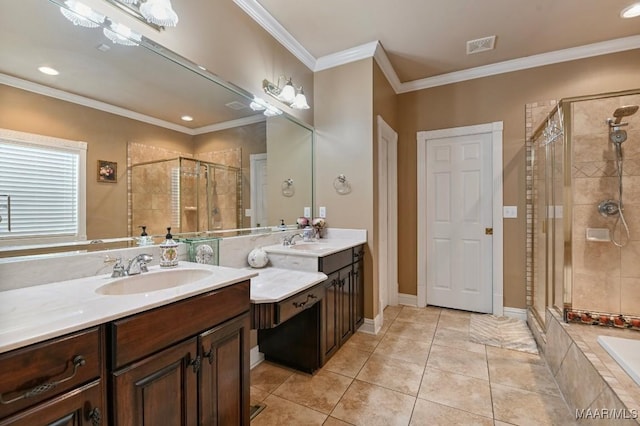 bathroom featuring a stall shower, tile patterned flooring, crown molding, and two vanities