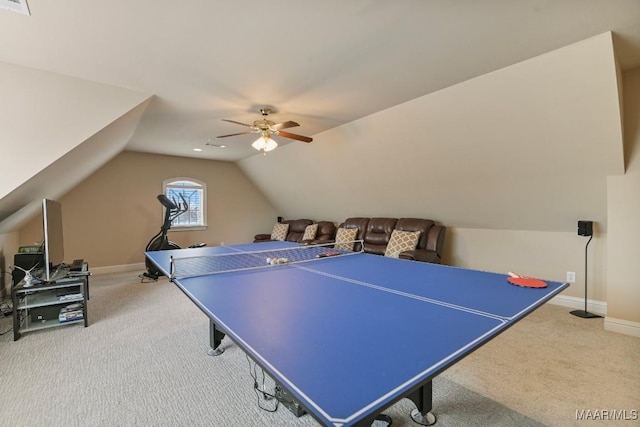 recreation room featuring carpet, ceiling fan, vaulted ceiling, and baseboards