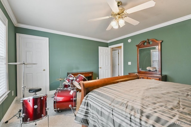 bedroom featuring crown molding, carpet floors, a ceiling fan, and baseboards