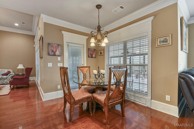 dining area featuring a chandelier, wood finished floors, crown molding, baseboards, and recessed lighting