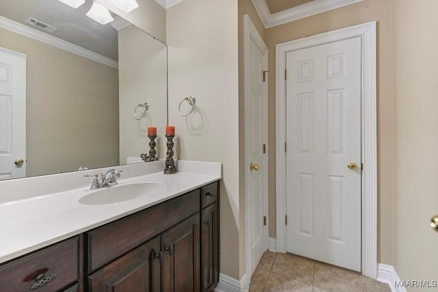 bathroom featuring crown molding, vanity, tile patterned flooring, baseboards, and a skylight
