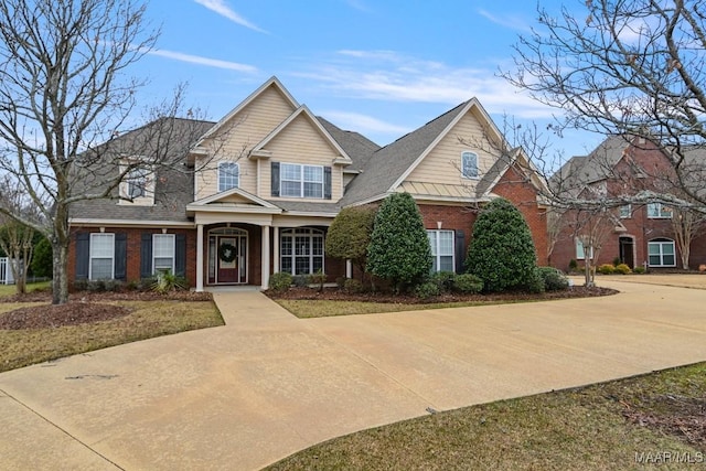 view of front of property featuring brick siding and a shingled roof