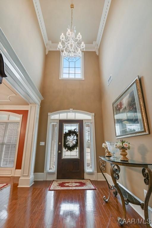8490 Rockbridge Cir, Montgomery, AL 36116 - foyer featuring ornamental molding, a chandelier, hardwood / wood-style floors, and a high ceiling