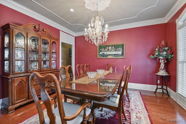 dining room featuring a chandelier, wood finished floors, and ornamental molding