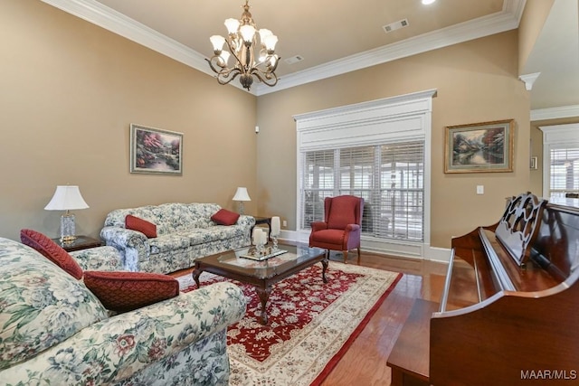 living room with a chandelier, wood finished floors, baseboards, and crown molding