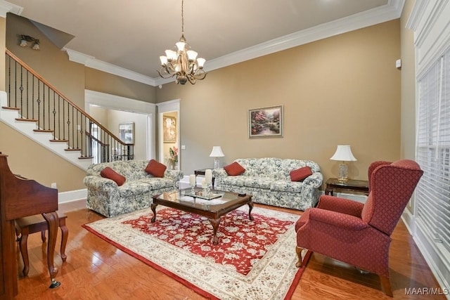 living area featuring wood finished floors, a chandelier, stairs, crown molding, and baseboards