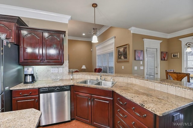 kitchen featuring stainless steel appliances, a sink, crown molding, pendant lighting, and decorative backsplash