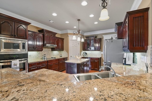 kitchen with stainless steel appliances, a sink, under cabinet range hood, backsplash, and crown molding