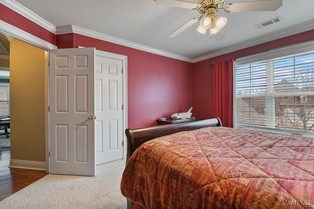 bedroom featuring ornamental molding, baseboards, carpet flooring, and a ceiling fan
