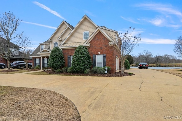 view of side of home featuring driveway and brick siding