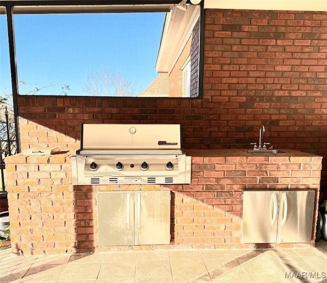 view of patio / terrace featuring a grill and a sink