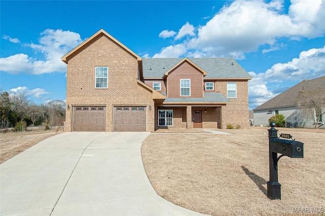 view of front of property with concrete driveway, brick siding, and an attached garage