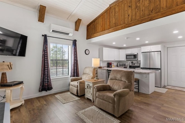 living room with recessed lighting, baseboards, a wall mounted AC, beam ceiling, and dark wood finished floors