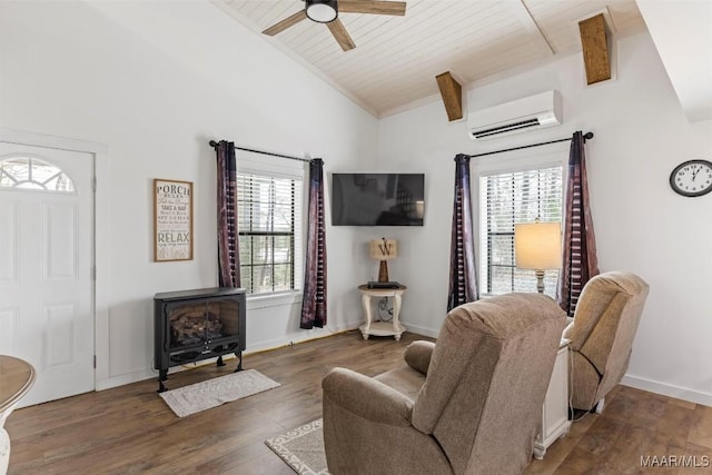 living room featuring lofted ceiling, dark wood-style flooring, baseboards, an AC wall unit, and a wood stove