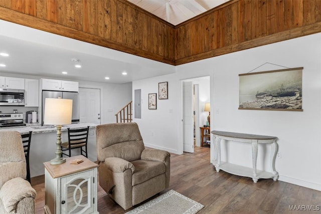 living area featuring stairway, recessed lighting, dark wood finished floors, and baseboards