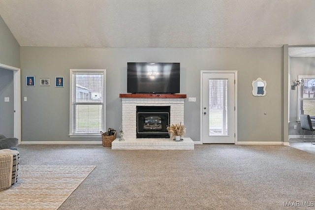 unfurnished living room featuring a textured ceiling, a fireplace, baseboards, and carpet flooring