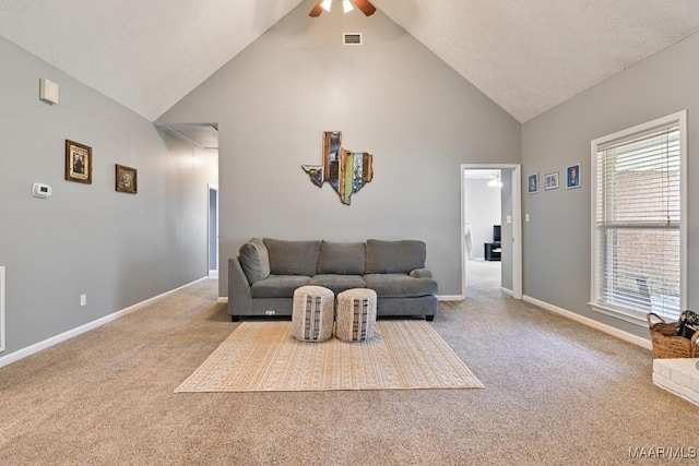 living room featuring light colored carpet, attic access, a ceiling fan, high vaulted ceiling, and baseboards